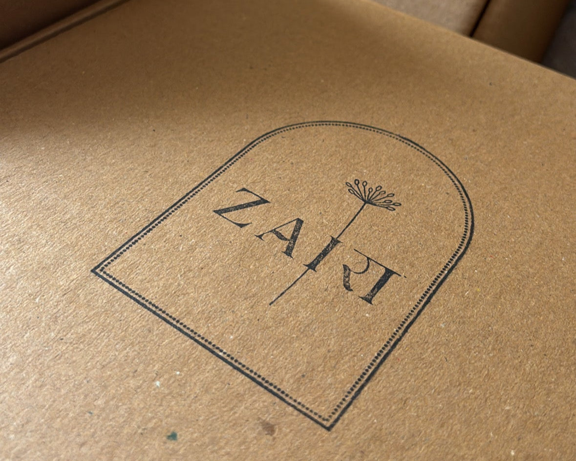 Brown cardboard box with 'Zaji' branding on a blurred background
